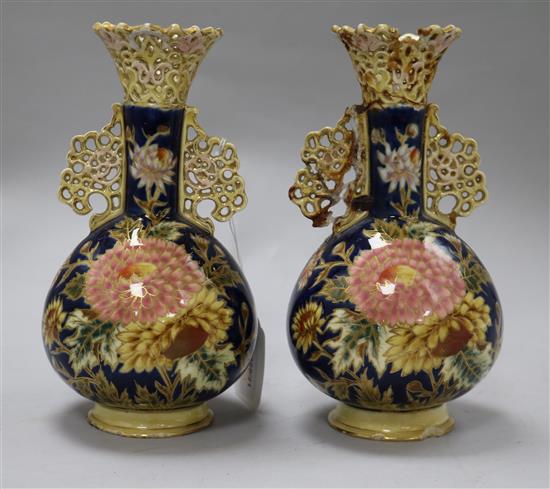 A pair of Zsolnay Pecs reticulated vases, floral-decorated on a blue ground and heightened in gilt height 20cm (a.f.)